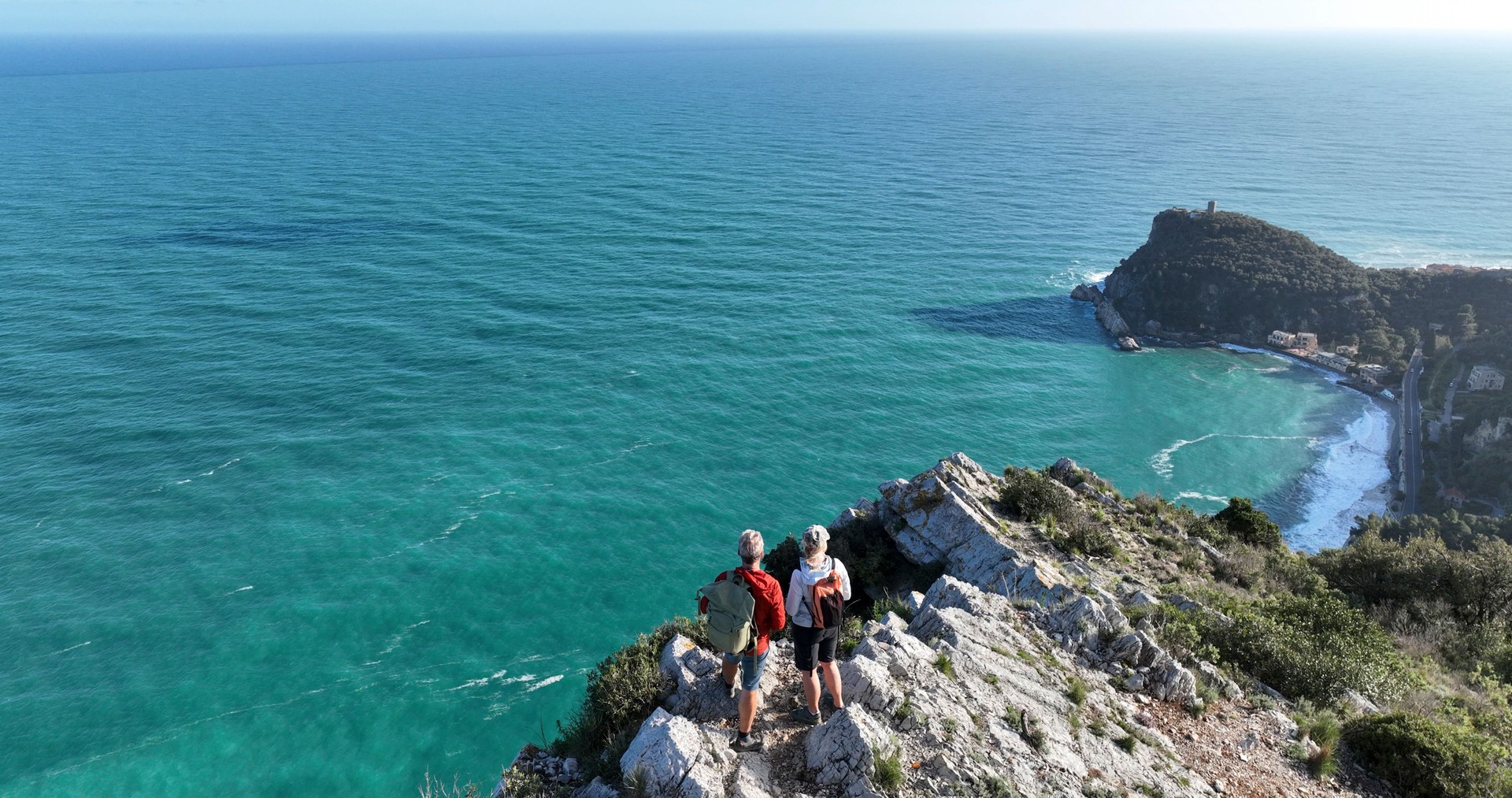 Aerial view of mature couple on cliff above sea